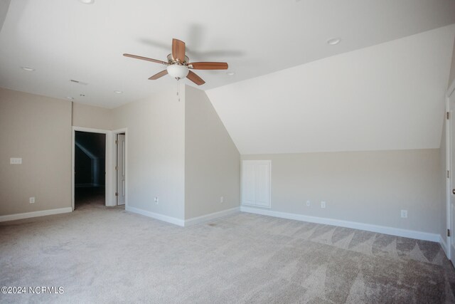 bonus room featuring ceiling fan, lofted ceiling, and light carpet