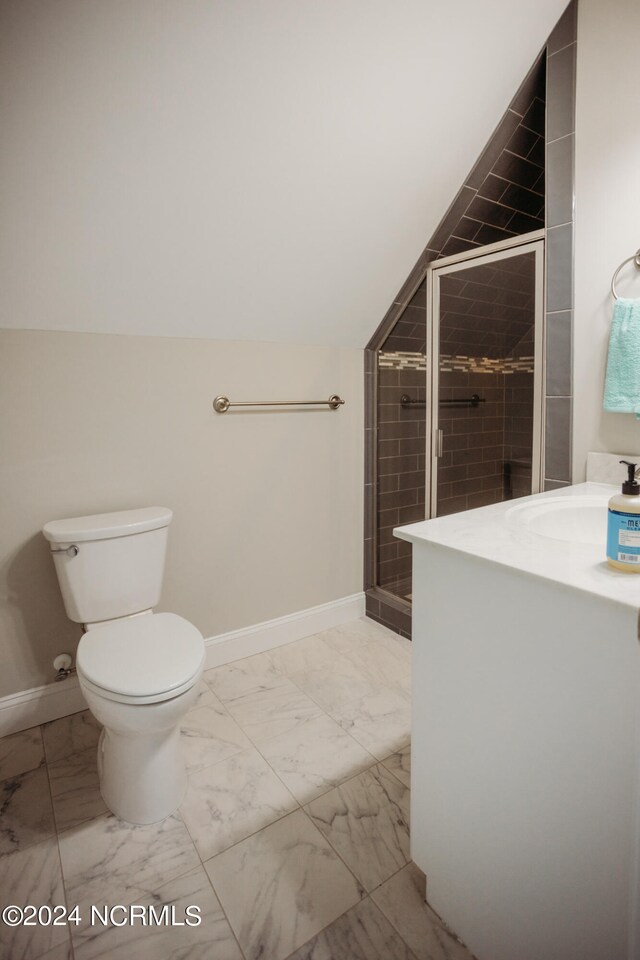 bathroom featuring vanity, lofted ceiling, toilet, and an enclosed shower