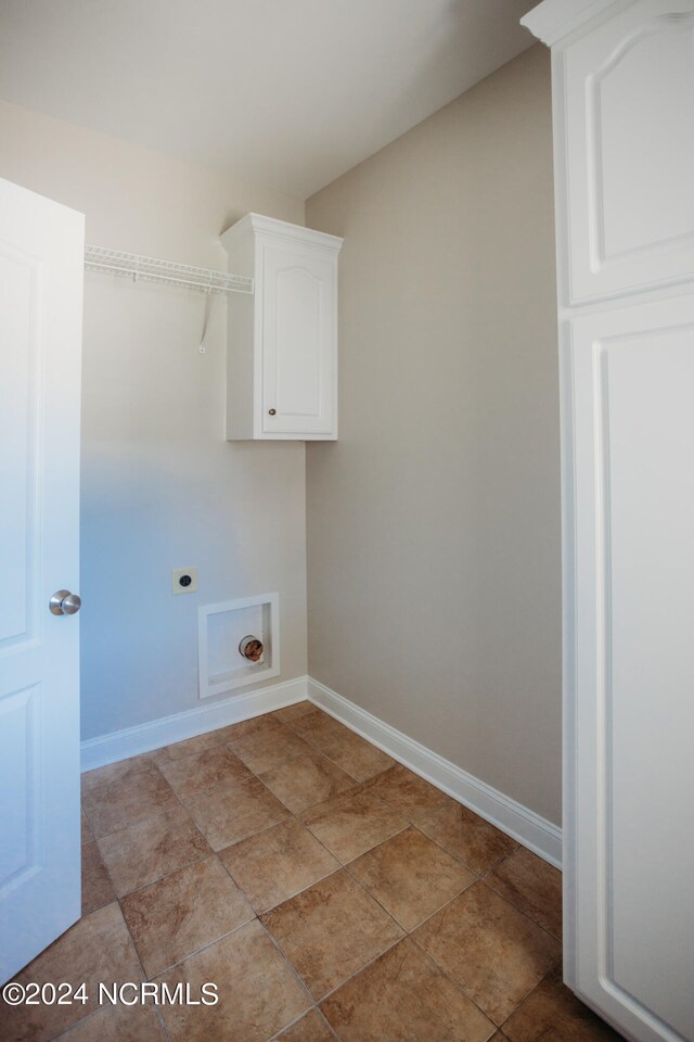 washroom featuring tile patterned floors, cabinets, and electric dryer hookup