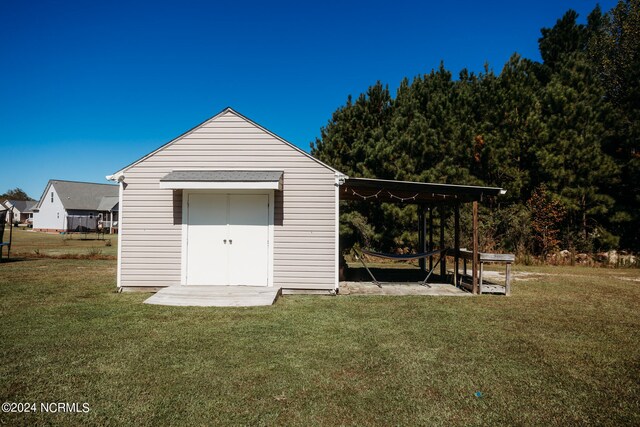 view of outbuilding with a lawn