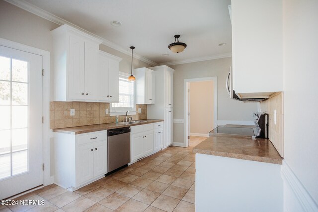 kitchen with appliances with stainless steel finishes, pendant lighting, white cabinetry, and backsplash