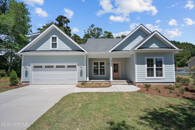 craftsman house with a garage and a front lawn