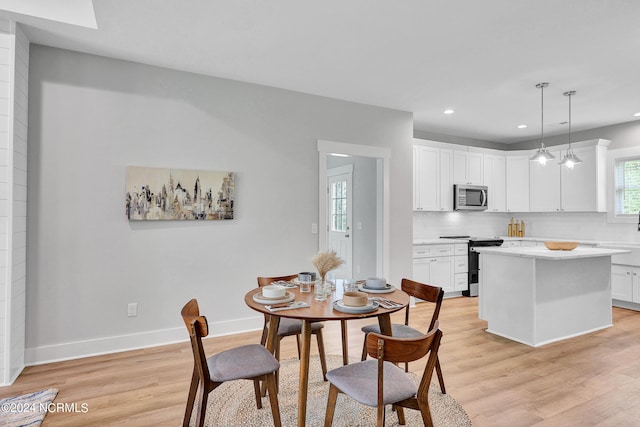 dining space with light wood-type flooring