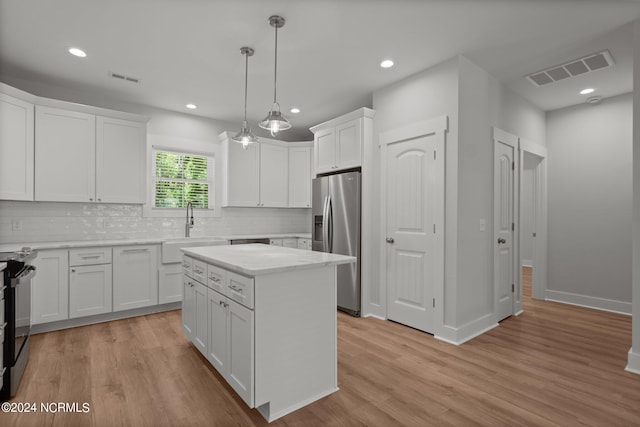 kitchen featuring white cabinetry, sink, light hardwood / wood-style flooring, and stainless steel fridge with ice dispenser