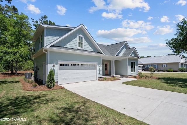 view of front facade featuring central AC, a garage, and a front lawn