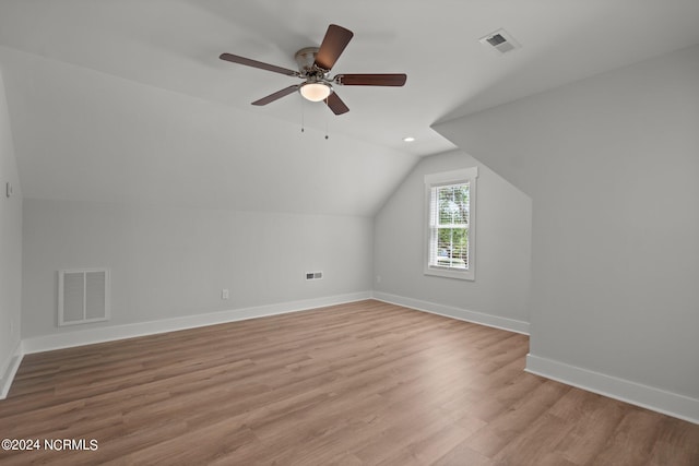 additional living space featuring ceiling fan, vaulted ceiling, and light wood-type flooring