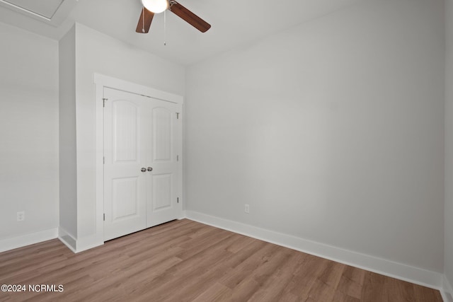 unfurnished bedroom with light hardwood / wood-style floors, a closet, and ceiling fan