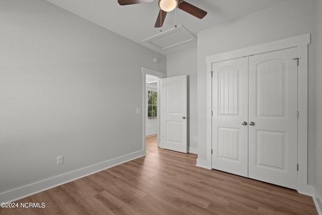 unfurnished bedroom featuring light hardwood / wood-style flooring, ceiling fan, and a closet