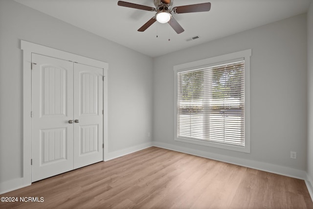 empty room featuring ceiling fan and light hardwood / wood-style floors