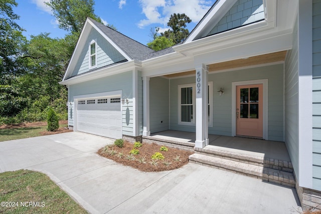 view of front facade featuring a garage and covered porch