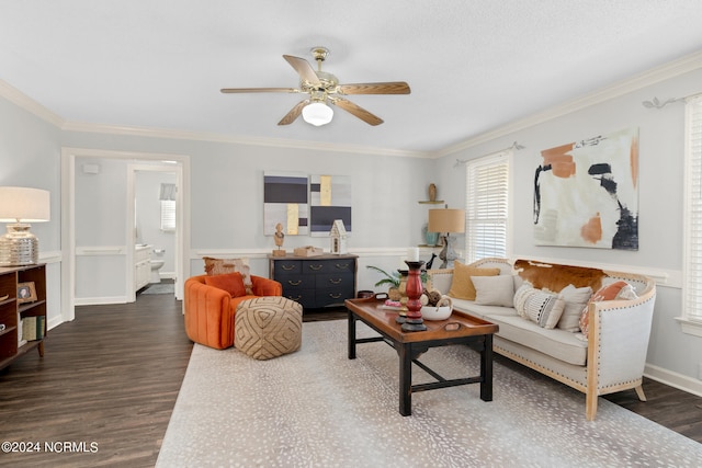 living room with ornamental molding, ceiling fan, and dark wood-type flooring