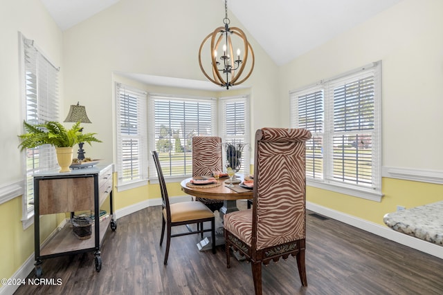 dining area with dark wood-type flooring, vaulted ceiling, and a chandelier