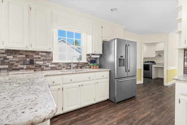 kitchen featuring light stone counters, ornamental molding, sink, stainless steel appliances, and dark hardwood / wood-style flooring