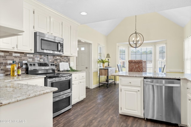 kitchen with white cabinets, appliances with stainless steel finishes, and decorative light fixtures