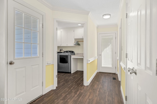 interior space featuring dark wood-type flooring, ornamental molding, and washing machine and clothes dryer