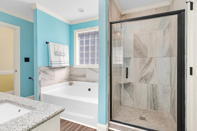 bathroom with hardwood / wood-style flooring, crown molding, vanity, and plus walk in shower