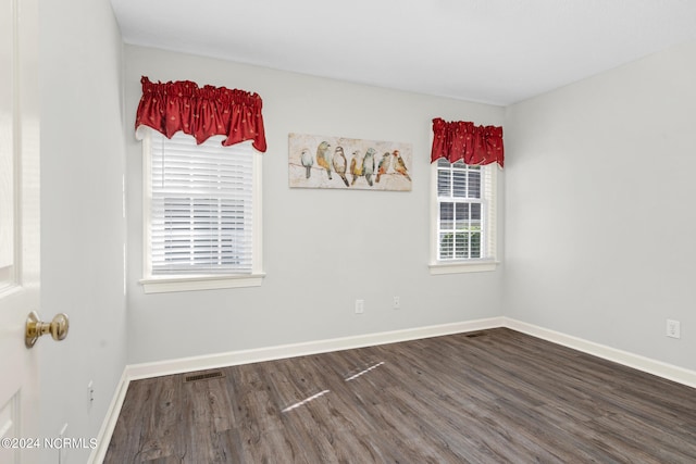 unfurnished room with dark hardwood / wood-style floors