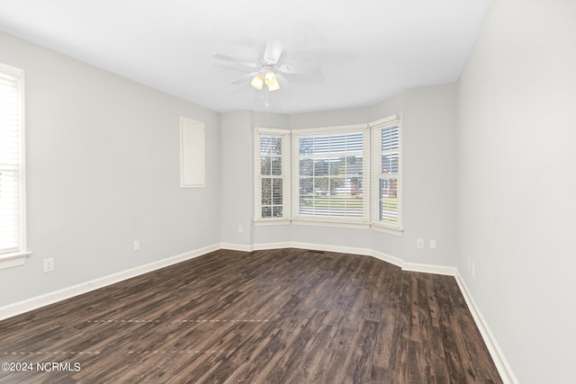 empty room featuring dark hardwood / wood-style flooring and ceiling fan