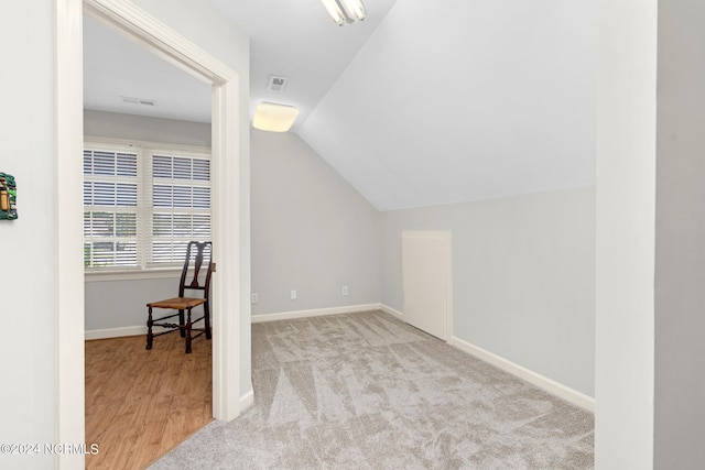 bonus room featuring vaulted ceiling and light hardwood / wood-style floors