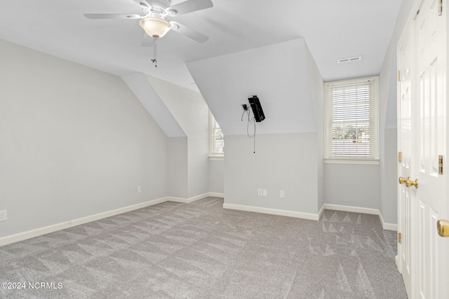 bonus room featuring ceiling fan, vaulted ceiling, and light carpet