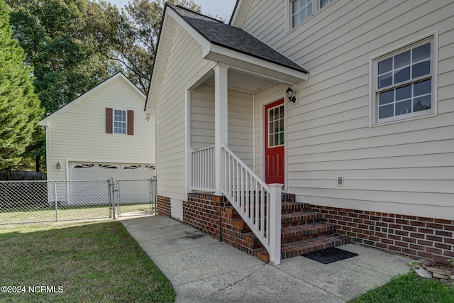 view of exterior entry with a yard