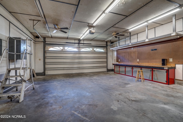 garage with a garage door opener and ceiling fan