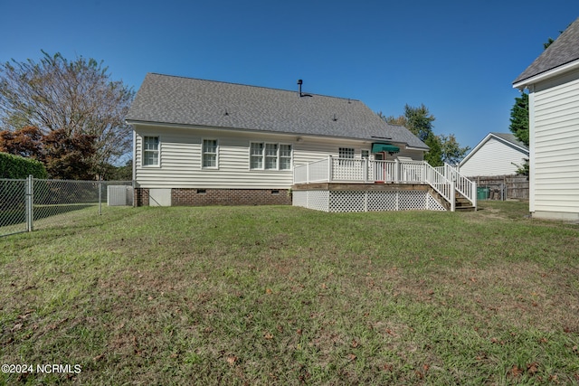 back of house featuring a yard and a deck