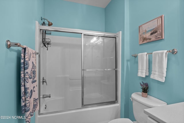 bathroom with shower / bath combination with glass door and toilet