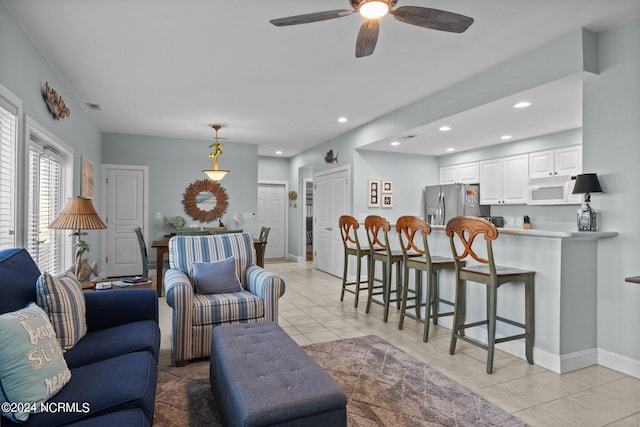 tiled living room with ceiling fan