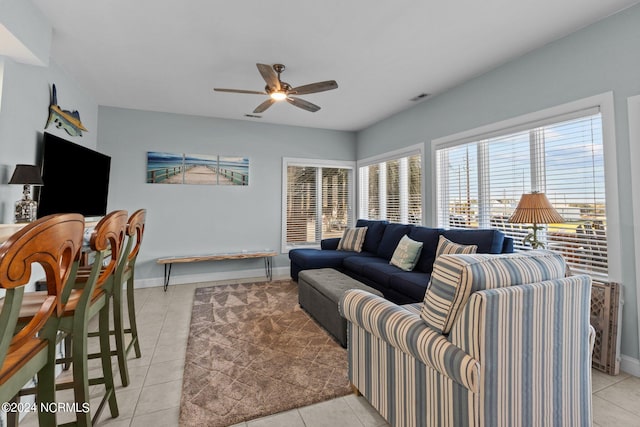 tiled living room with ceiling fan