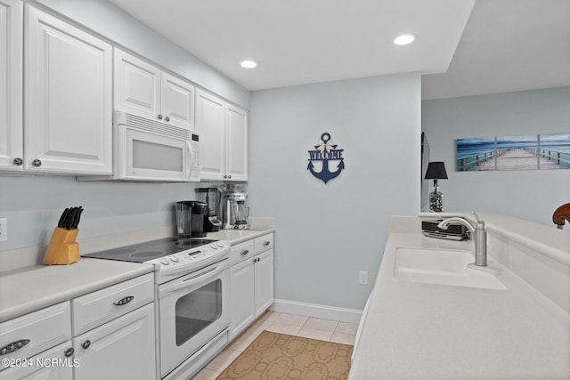 kitchen featuring sink, white cabinets, white appliances, and light tile patterned floors