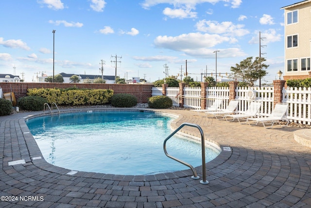 view of swimming pool featuring a patio