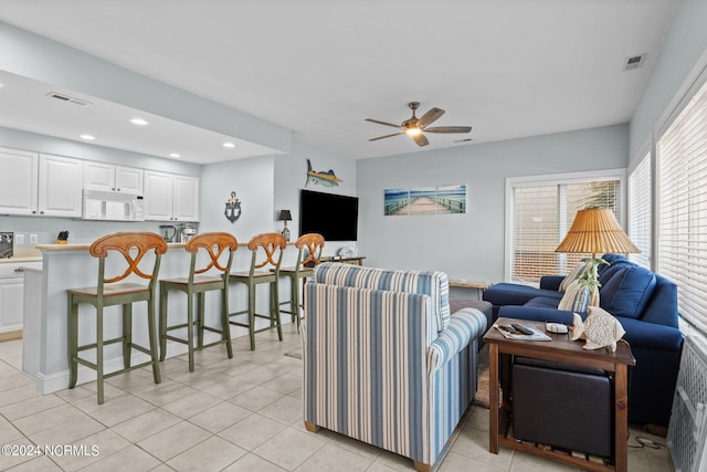 living room featuring ceiling fan and light tile patterned flooring