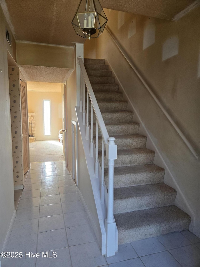 stairway with tile patterned flooring