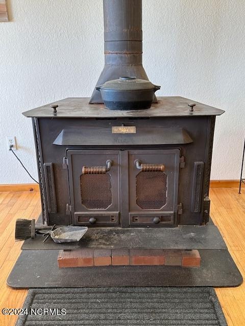 details with hardwood / wood-style floors and a wood stove