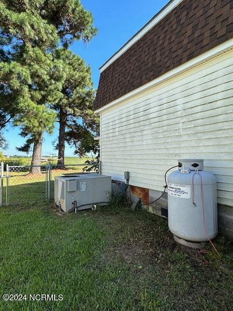 view of side of home with a yard