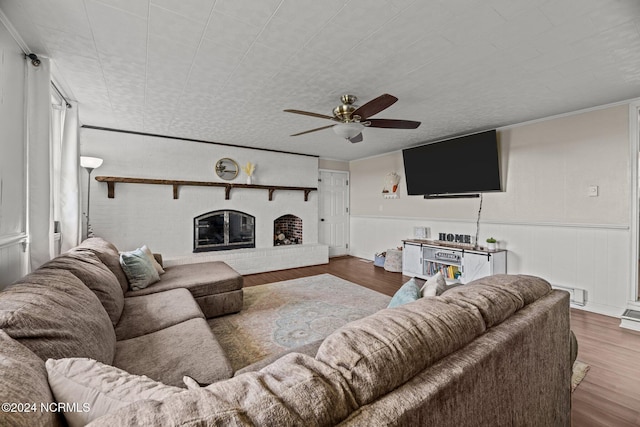 775 Gray Rd, Vanceboro, NC 28586 - living room featuring wood finished floors, ceiling fan, wainscoting, and a brick fireplace
