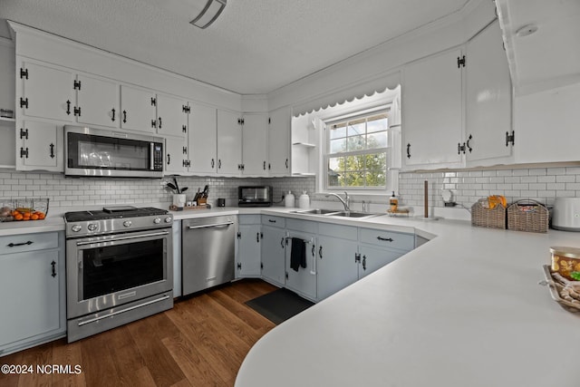 775 Gray Rd, Vanceboro, NC 28586 - kitchen featuring appliances with stainless steel finishes, light countertops, white cabinets, dark wood-type flooring, and a textured ceiling