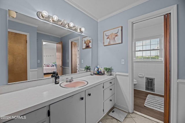 bathroom with wood-type flooring, crown molding, vanity, and toilet