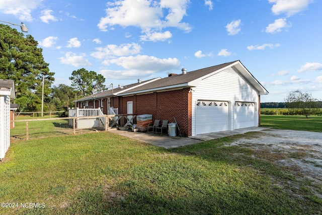 view of home's exterior featuring a lawn and a wooden deck