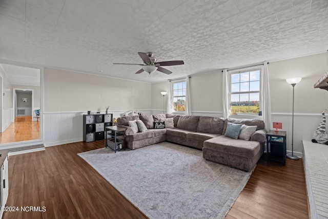 living room featuring a textured ceiling, dark hardwood / wood-style floors, and ceiling fan