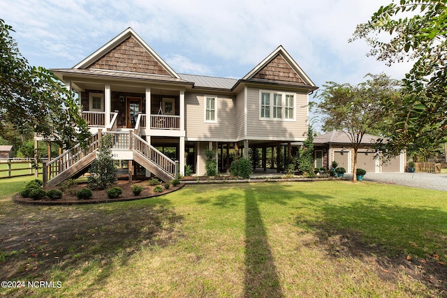 view of front of house with a porch, a garage, and a front yard