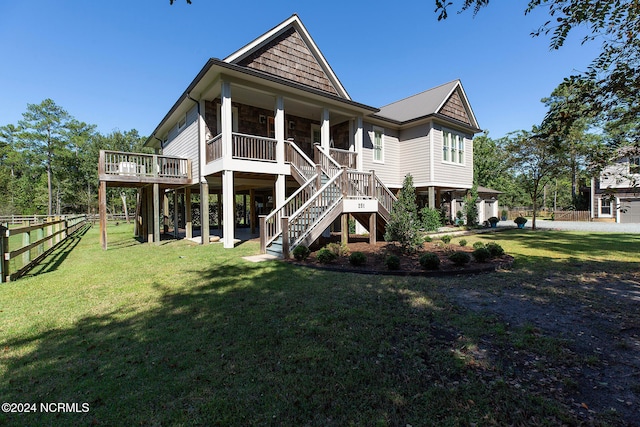 rear view of house with a yard and a wooden deck