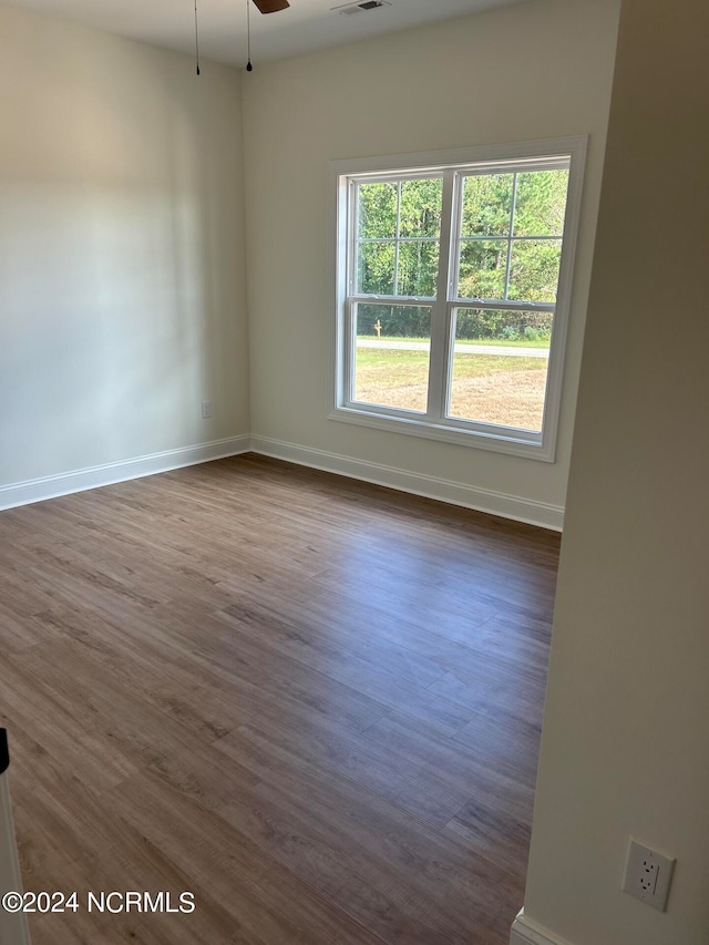 spare room featuring ceiling fan and dark hardwood / wood-style flooring