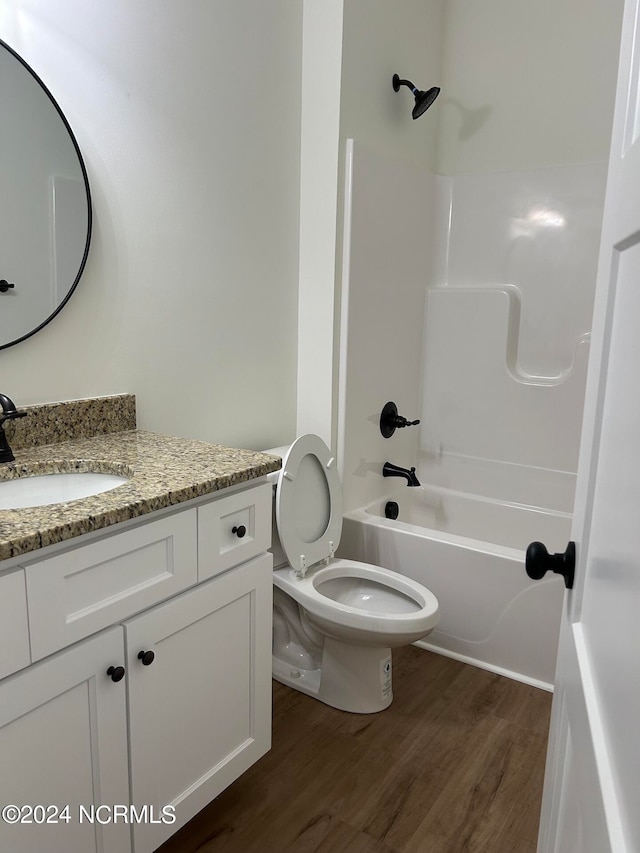 full bathroom featuring shower / tub combination, hardwood / wood-style flooring, vanity, and toilet