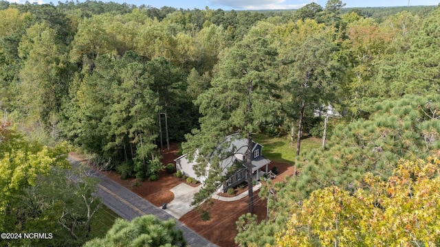 birds eye view of property with a forest view