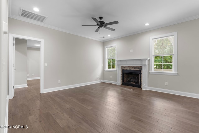 unfurnished living room featuring ceiling fan, a healthy amount of sunlight, a stone fireplace, and visible vents