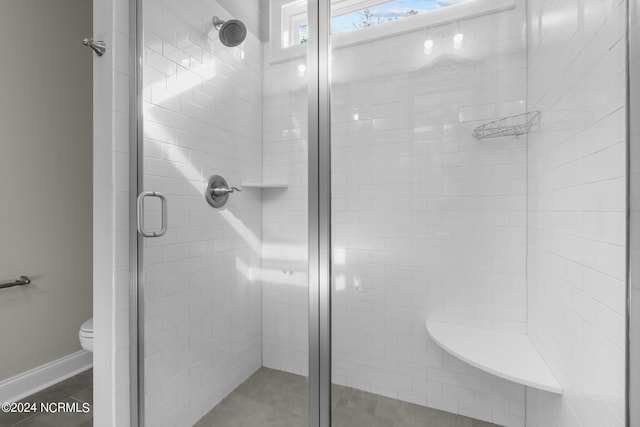 full bathroom with a shower stall and toilet