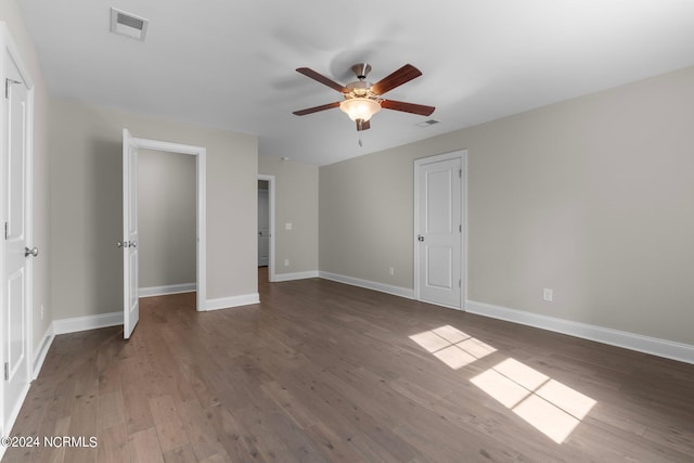 unfurnished bedroom featuring baseboards, a ceiling fan, wood finished floors, and visible vents
