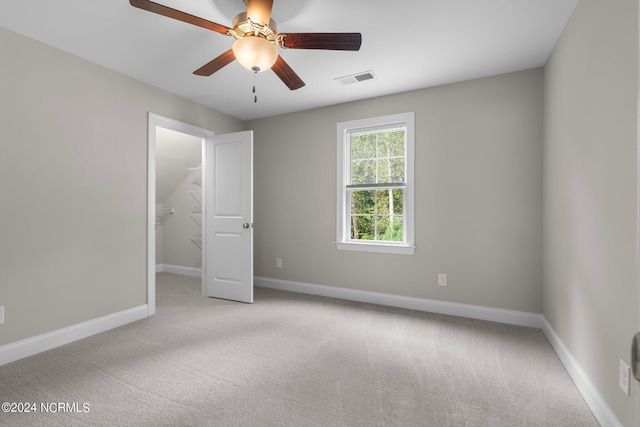 interior space with carpet flooring, baseboards, and ceiling fan
